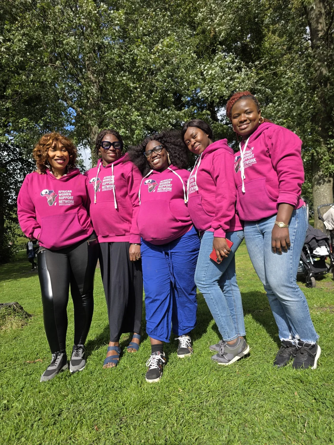 AWSN women standing together outdoors in matching pink shirts